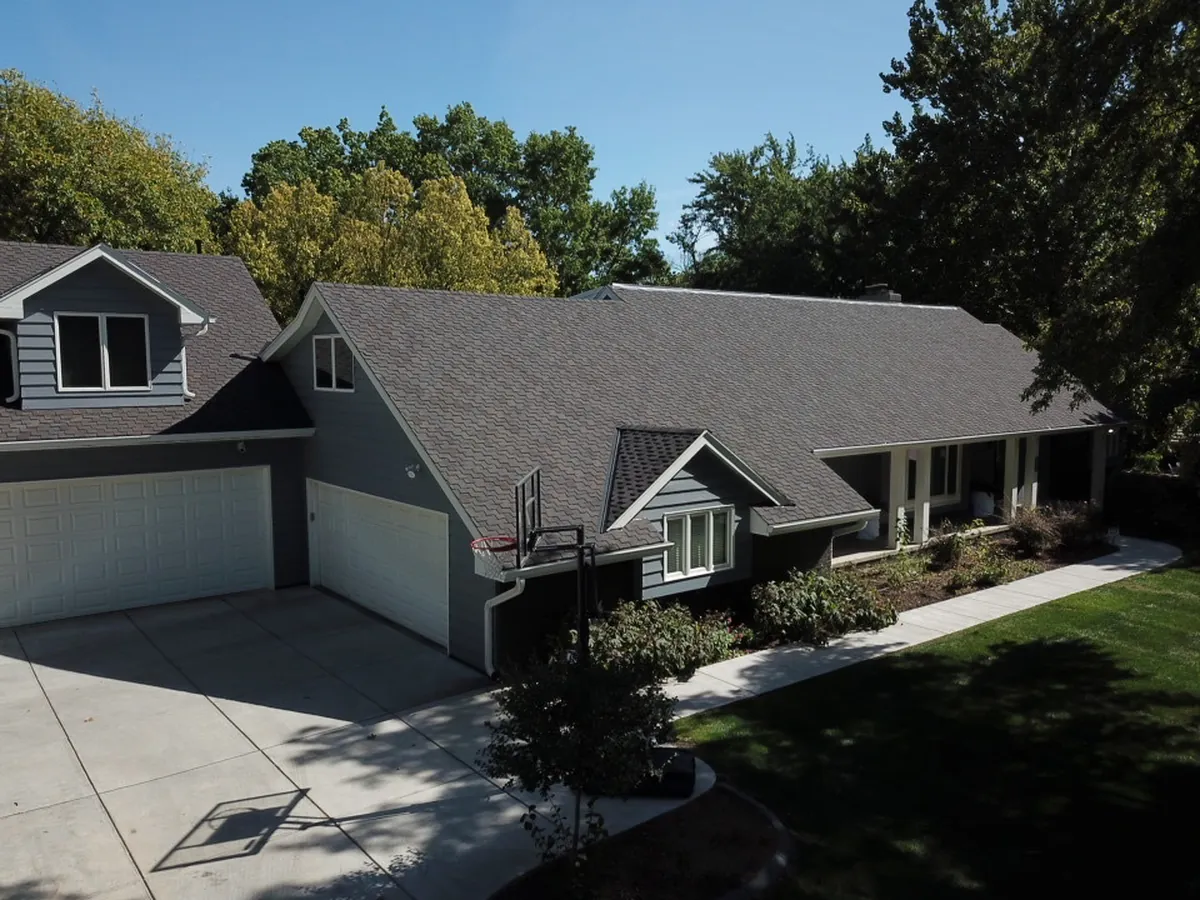 Long seamless gutter run and downspout on a low-slung roofline
