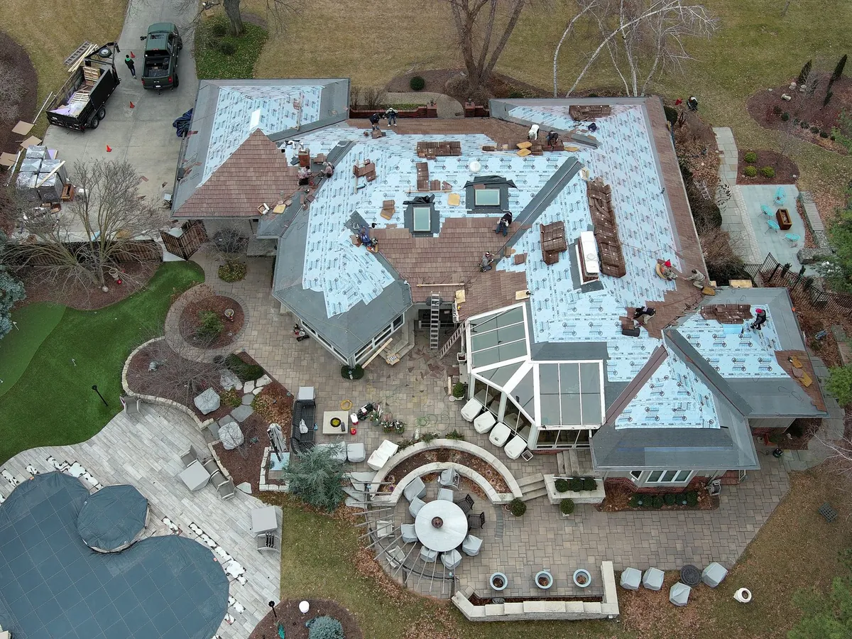 Roof replacement in progress — old shingles off and underlayment going down
