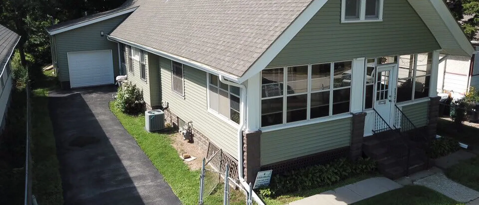 A wall of replacement windows across an enclosed front porch